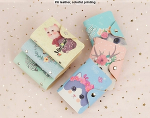 Detail of colorful PU leather card holders with cute cartoon prints and metal buckles