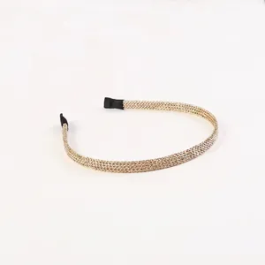 Minimalist golden metal mesh headband with a sleek honeycomb weave and black anti-slip ends