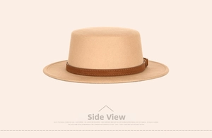 Detail of beige flat top fedora with brown leather strap and buckle adjustment