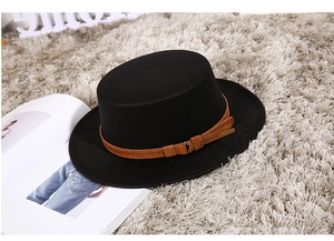 Detailed texture of black wool felt flat top boater hat with a brown decorative band