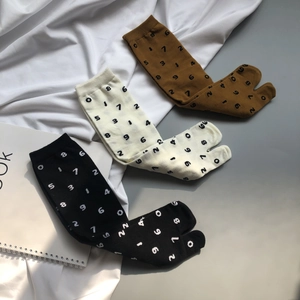 Three-pack of Tabi socks in black, white, and brown featuring unique digital print patterns