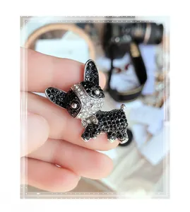 Close-up of sparkling black and white rhinestone-encrusted French Bulldog lapel pin