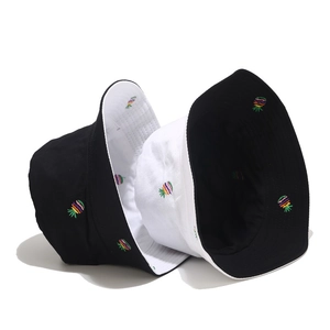 Detail of pineapple embroidery on reversible black and white sun bucket hats