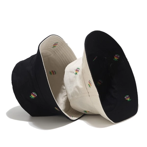 Detail of embroidered pineapple pattern and textured cotton fabric on double-sided bucket hat