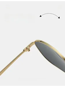 Macro detail of a durable gold metal hinge on retro oval sunglasses with grey lenses
