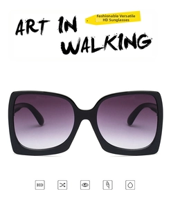 Detail view of oversized square sunglasses with black frame and purple gradient lenses