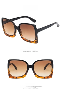 Detail view of square oversized sunglasses featuring black and leopard print spliced frames