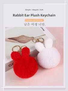 Close-up of plush bunny ear keychains in red and white with gold lobster clasps