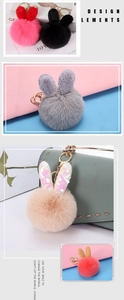 Detail of plush bunny ear pompom keychains in various colors on a green handbag