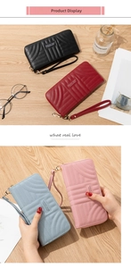 Detail showing women's long zip wallets with wave quilting and detachable wrist straps