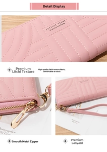 Close-up of pink long wallet showing litchi grain texture, metal zipper and wrist strap