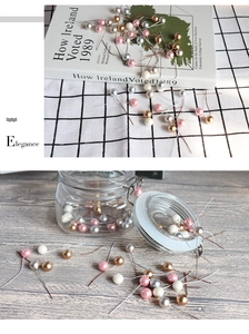 Close-up of 12mm artificial berries with metallic stems for DIY flower arrangements