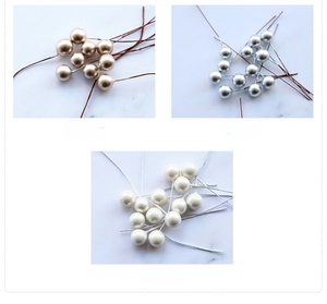 Detailed macro view of 10mm champagne silver and pearl white artificial craft berries