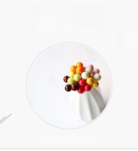 Macro shot of 10mm colorful artificial foam berries in a minimalist white vase decoration