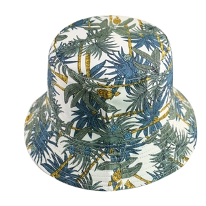 Stylish women's summer sun bucket hat with vibrant tropical palm tree and pineapple print
