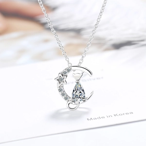 Silver moon and cat pendant necklace with sparkling cubic zirconia on a white card