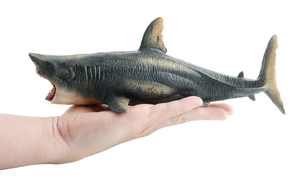 Detailed close-up of a great white shark toy model showing teeth and texture in hand