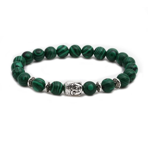 Detail of beaded bracelet with green malachite stones and silver Buddha head charm