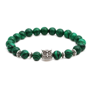 Malachite beaded bracelet with silver owl charm and hollow metal spacer beads on white background
