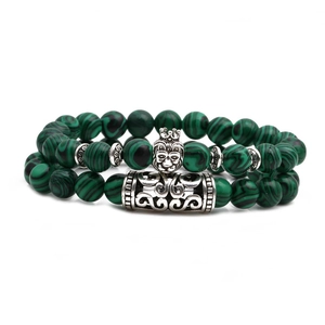 Detailed shot of green malachite beads with silver crown lion head and vintage tube charm