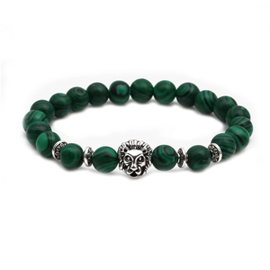 Detailed shot of malachite green beaded bracelet featuring a vintage silver lion head