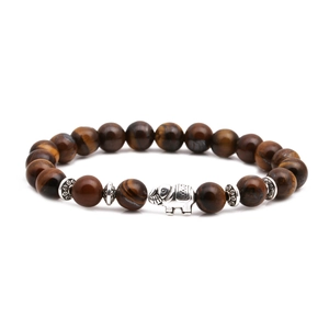 Macro view of tiger eye bead bracelet with detailed silver elephant charm and spacers