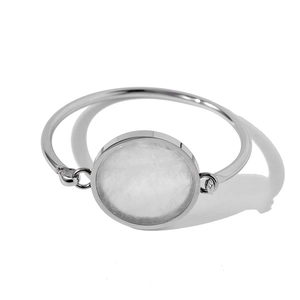 Detailed view of silver cuff bracelet featuring a round white translucent gemstone inlay