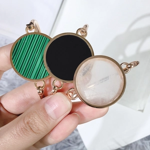 Detailed close-up of rose gold bangles with malachite, onyx, and white crystal inserts