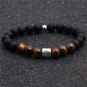 Detail of Scorpio zodiac bracelet featuring black matte beads and natural tiger eye stone