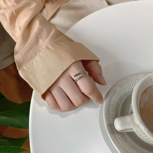 Detail of minimalist 925 sterling silver double-layered open ring on a model's hand