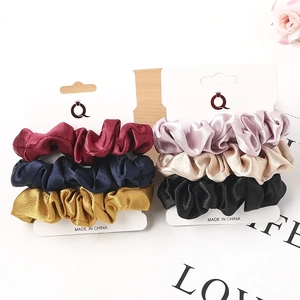 Close-up of 6-piece satin scrunchies set in candy colors on white display cards