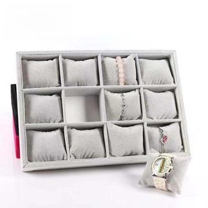 Detail view of 12-slot gray velvet jewelry display tray with soft watch pillows