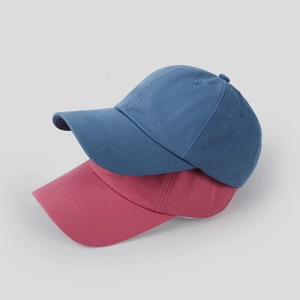 Minimalist cotton baseball caps in navy blue and peach pink shown in a stacked layout