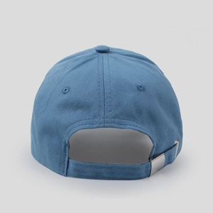 Close-up of blue cotton baseball cap rear with adjustable metal buckle and twill fabric