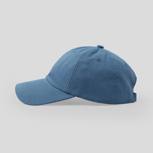 Side view of dark blue cotton baseball cap with ventilation eyelets and curved brim