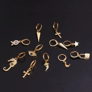 Minimalist gold hoop earrings featuring celestial stars, crosses, and sea horse charms