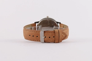 Close-up of the silver metal case back and camel leather strap with a pin buckle