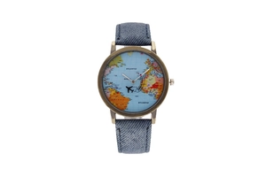 Detail of world map watch face with airplane hand and blue denim strap in bronze case