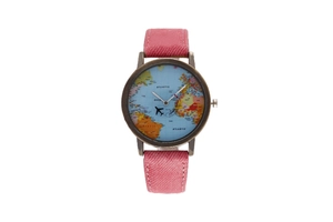 Detail of world map watch face with airplane needle and pink denim strap