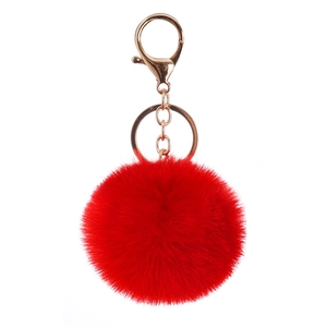 Red faux rabbit fur ball keychain with gold metal ring and lobster clasp on white background