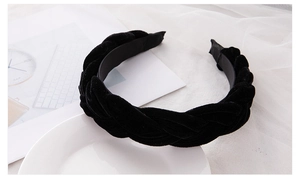 Detail of a braided black velvet headband showing soft texture and fine woven craftsmanship