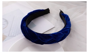 Close-up of braided dark blue velvet headband showing soft texture and woven detail