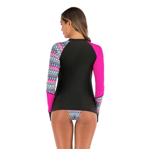 Detail view of women's long sleeve rash guard with contrast pink and wave print sleeves
