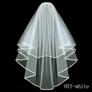Short double-layered off-white wedding veil with piped edges for bridal party photos