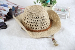 Detail of hollow woven straw cowboy hat with brown leather band and adjustable wind rope