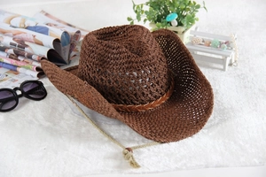 Detail of dark brown woven straw cowboy hat with hollow breathable design and chin strap