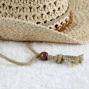 Hollow out woven straw sun hat for women featuring a stylish decorative wooden bead cord