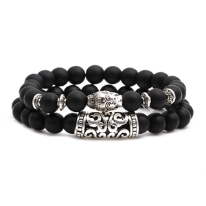 Matte black onyx beaded bracelet set with silver Buddha head and textured tube spacer