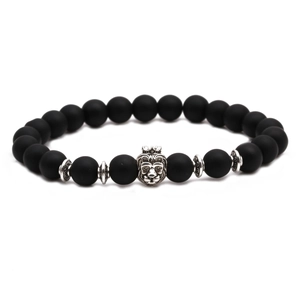 Close-up of matte black agate beads bracelet with a detailed silver lion head charm