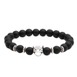 Detailed shot of a black matte stone bead bracelet featuring a silver leopard head charm